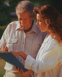 Immagine di una donna medico esaminando un grafico con un paziente
